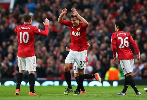 Robin van Persie of Manchester United celebrates scoring his second goal with Wayne Rooney and Shinji Kagawa during the Barclays Premier League match between Manchester United and Aston Villa at Old Trafford on April 22, 2013 in Manchester, England. (Photo by Alex Livesey/Getty Images)